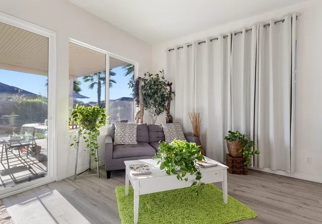 a room with potted plants and a wooden floor