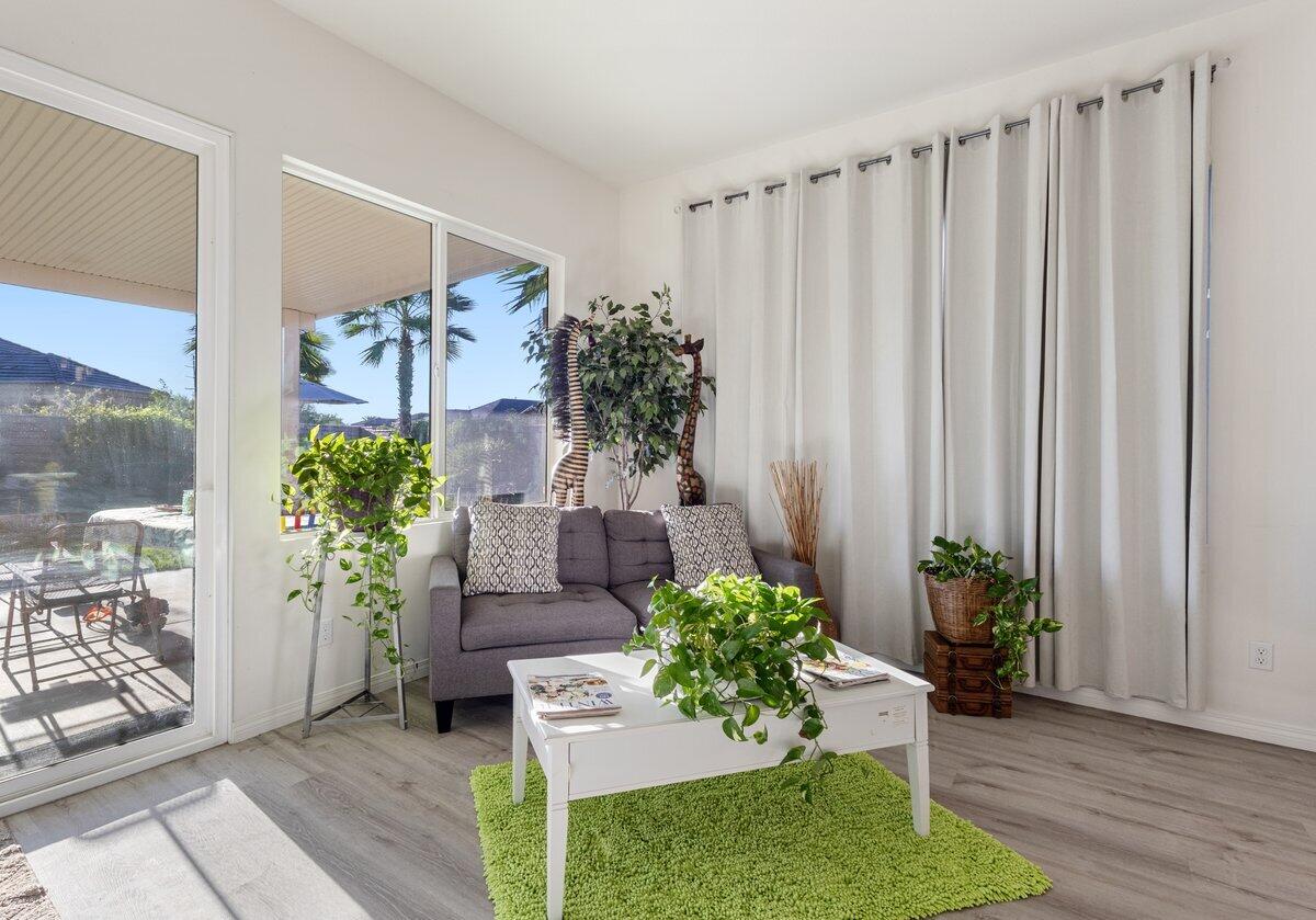 44027 Triolo Way Indio, CA 92203 - Photo 4 of 17 a room with potted plants and a wooden floor