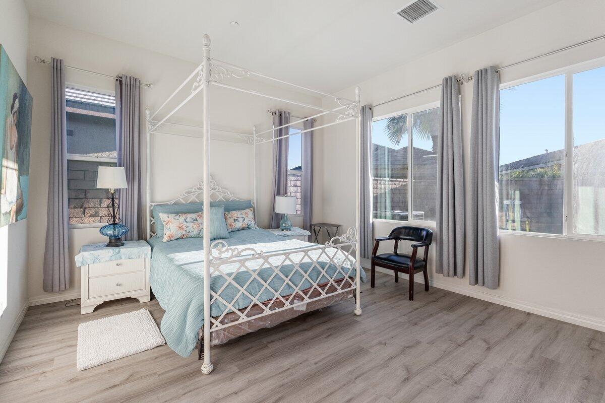 44027 Triolo Way Indio, CA 92203 - Photo 7 of 17 a bedroom with a bed and a large window