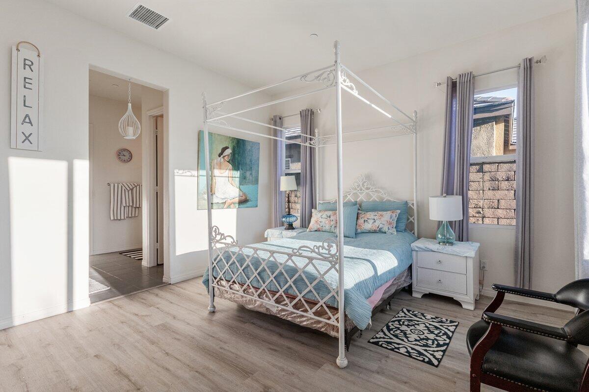 44027 Triolo Way Indio, CA 92203 - Photo 8 of 17 a bedroom with a bed and wooden floor