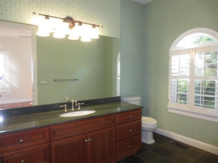 36 Open Space Drive Sandwich, MA 02563 - Photo 26 of 35 a bathroom with a granite countertop toilet a sink and a mirror