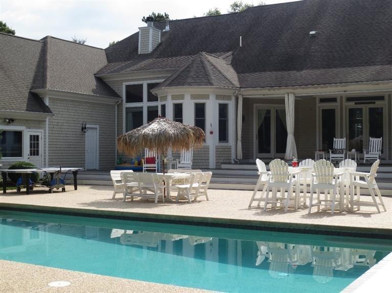 36 Open Space Drive Sandwich, MA 02563 - Photo 5 of 35 a front view of a house with swimming pool table and chairs