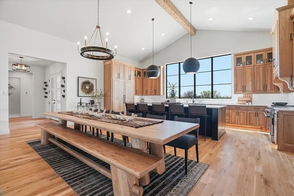 a large kitchen with a table and chairs
