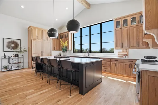 a kitchen with a large counter top space a sink appliances and cabinets