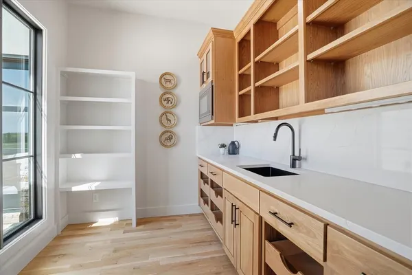 a kitchen with stainless steel appliances cabinets and a window