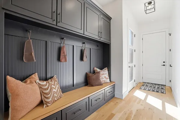 a hallway with white cabinets
