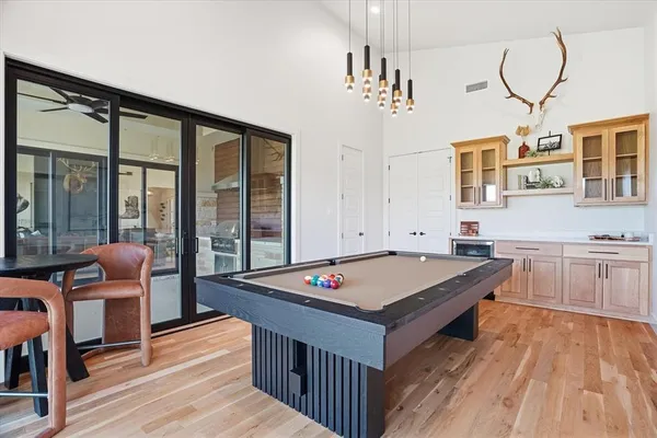 a room with furniture pool table and flat screen tv