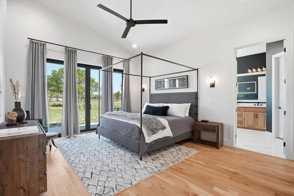 a bedroom with a large bed and a large window