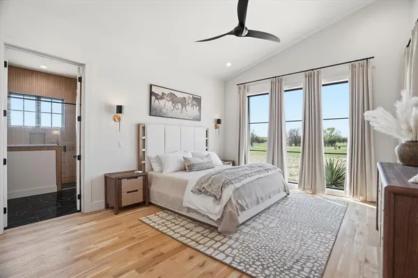 a bedroom with a large bed and a large window
