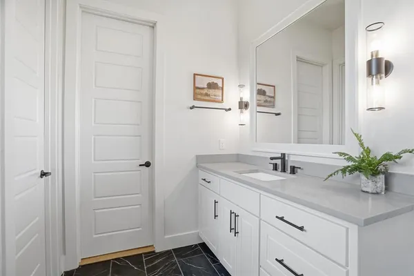a bathroom with a sink a vanity and a mirror