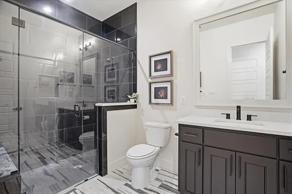 a bathroom with a toilet sink and shower
