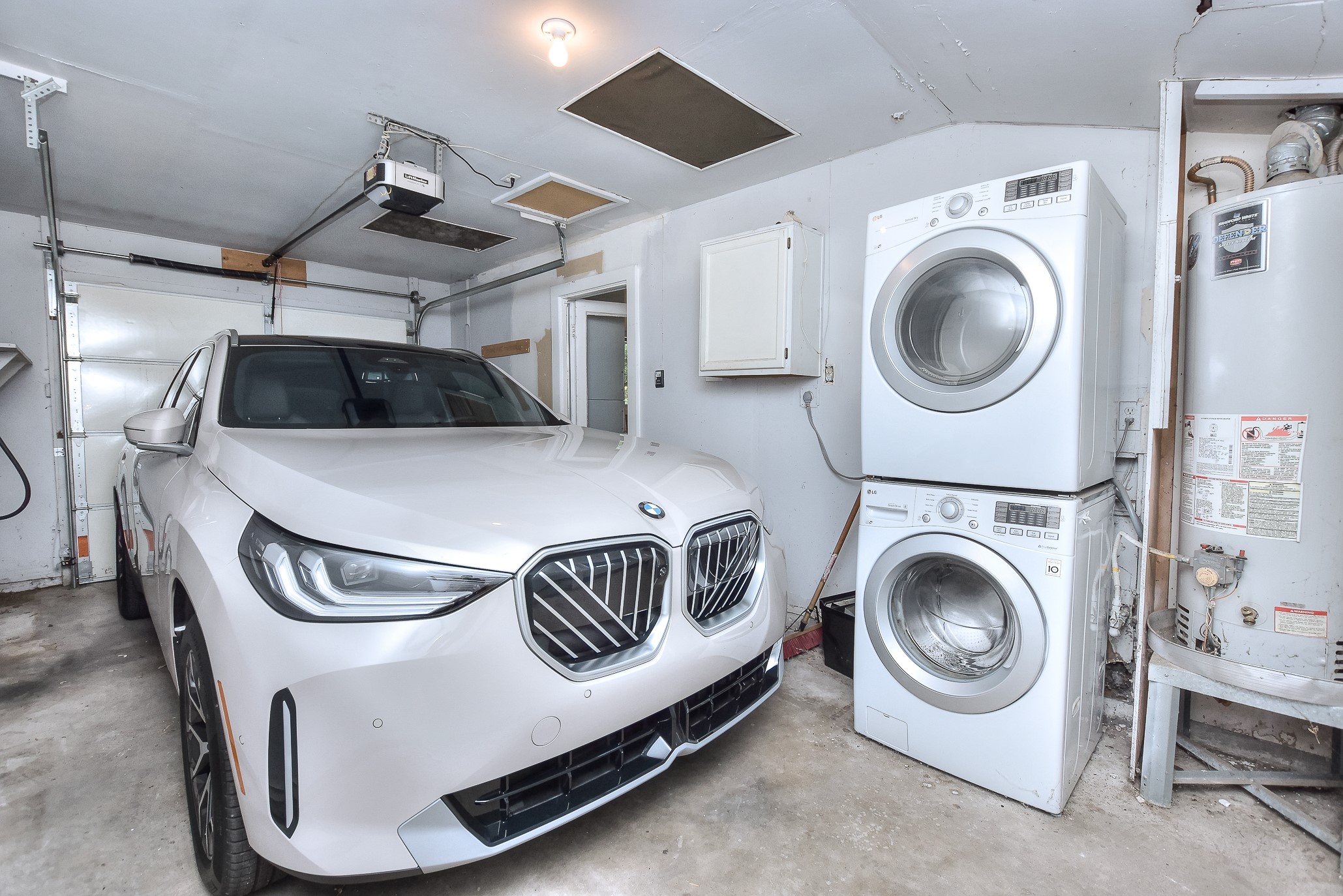 1309 Ridgemont Drive Austin, TX 78723 - Photo 27 of 35 Rare attached, enclosed 1 car garage with garage door opener, EV charging and stackable washer and dryer (that convey!) There is a back door providing direct access to the private backyard!