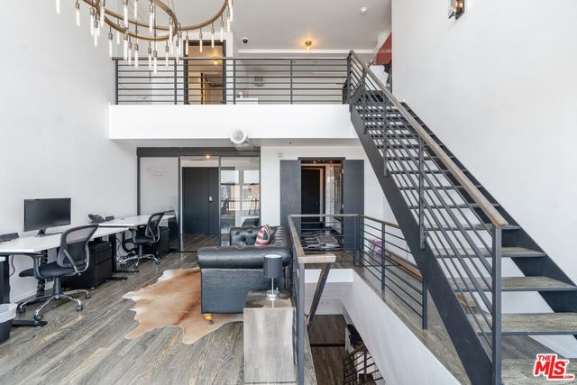a view of a livingroom with furniture and workspace