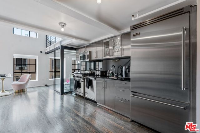 a kitchen with stove and refrigerator