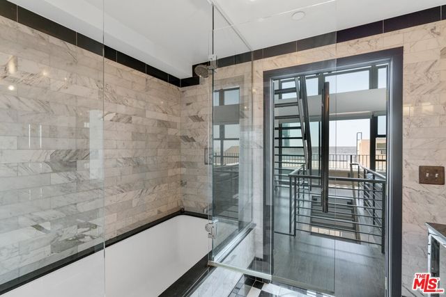 a bathroom with a bathtub and shower