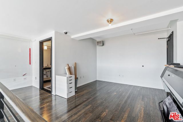 a view of a kitchen with furniture and wooden floor