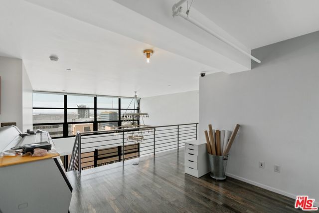 a view of a workspace with furniture and stairs