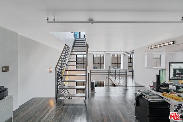 a view of a livingroom with furniture and staircase