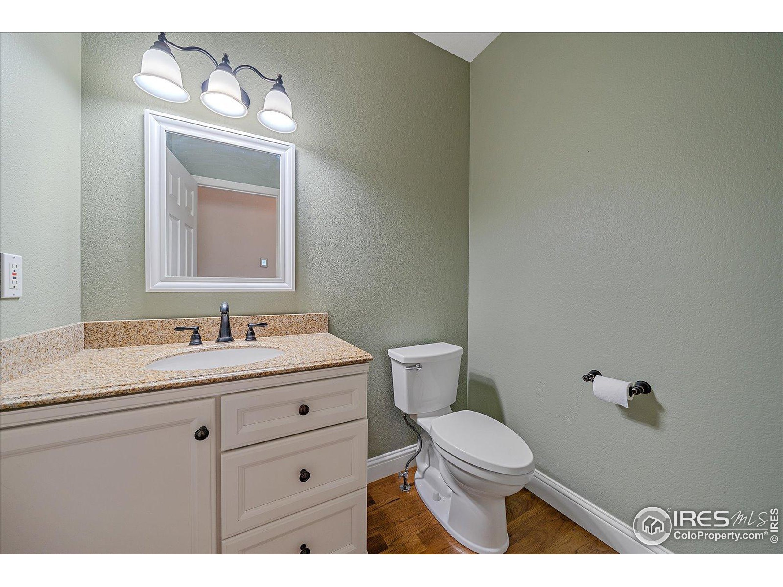 1320 West 12th Avenue Broomfield, CO 80020 - Photo 19 of 50 a bathroom with a toilet a sink and mirror
