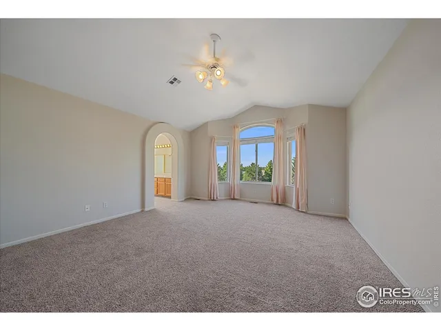 a view of a livingroom with a ceiling fan and window