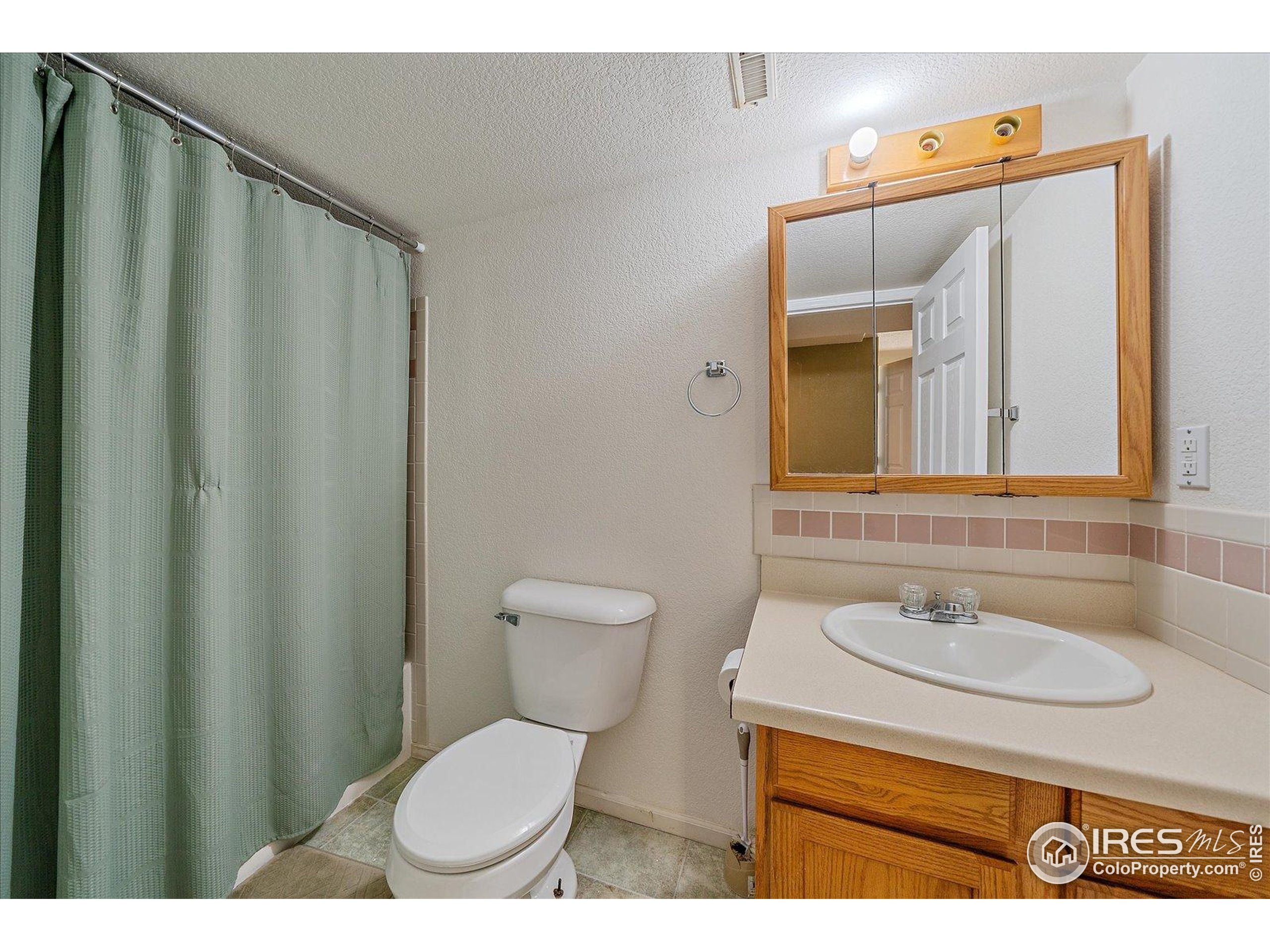 1320 West 12th Avenue Broomfield, CO 80020 - Photo 33 of 50 a bathroom with a sink toilet and mirror