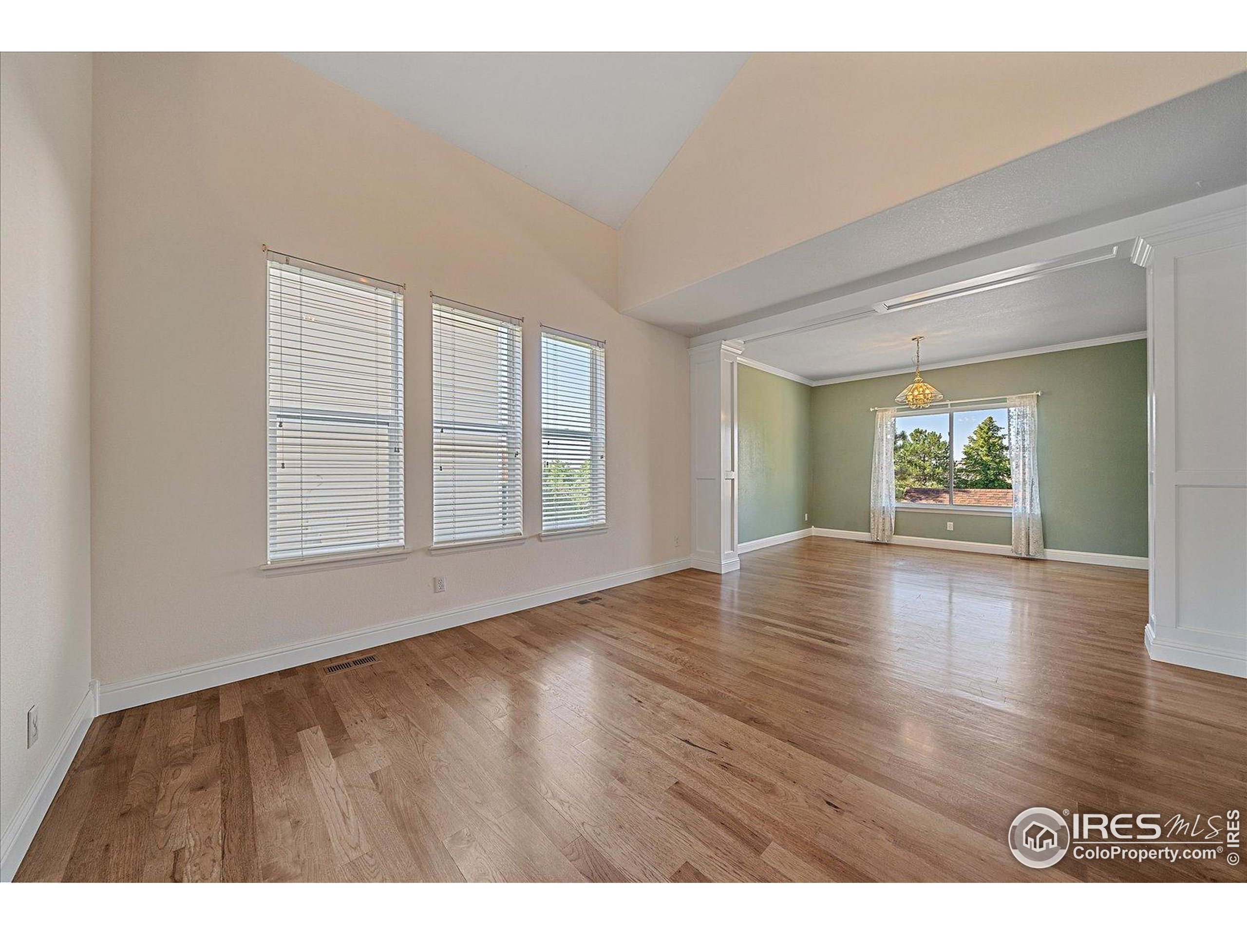 1320 West 12th Avenue Broomfield, CO 80020 - Photo 5 of 50 a view of an empty room with window and wooden floor