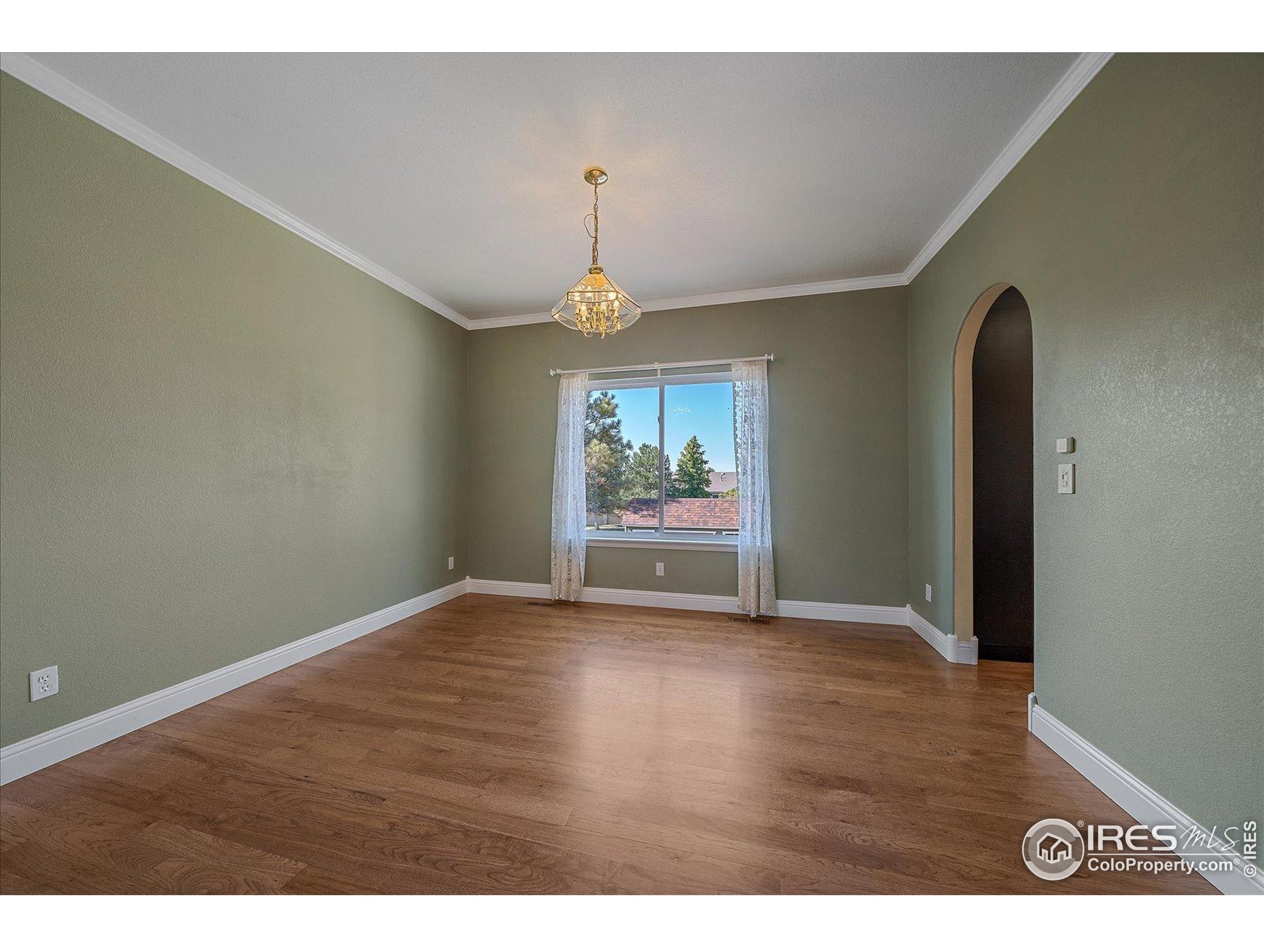 1320 West 12th Avenue Broomfield, CO 80020 - Photo 7 of 50 a view of an empty room with wooden floor and a window
