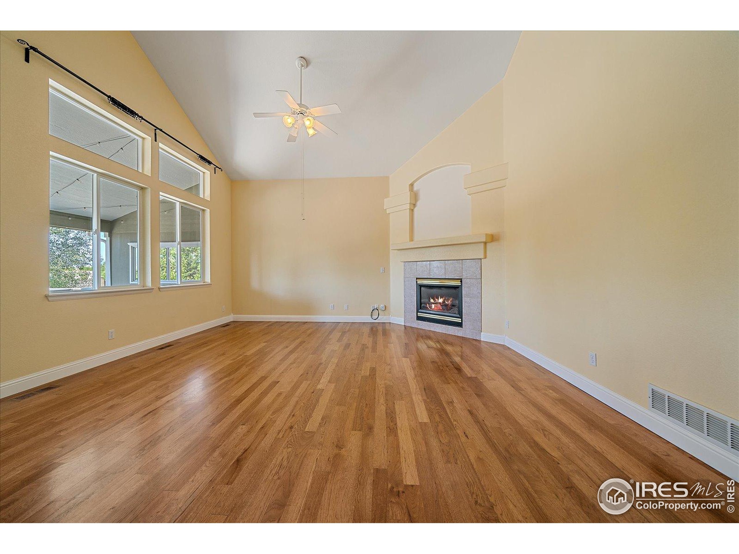 1320 West 12th Avenue Broomfield, CO 80020 - Photo 9 of 50 a view of an empty room with wooden floor and a window