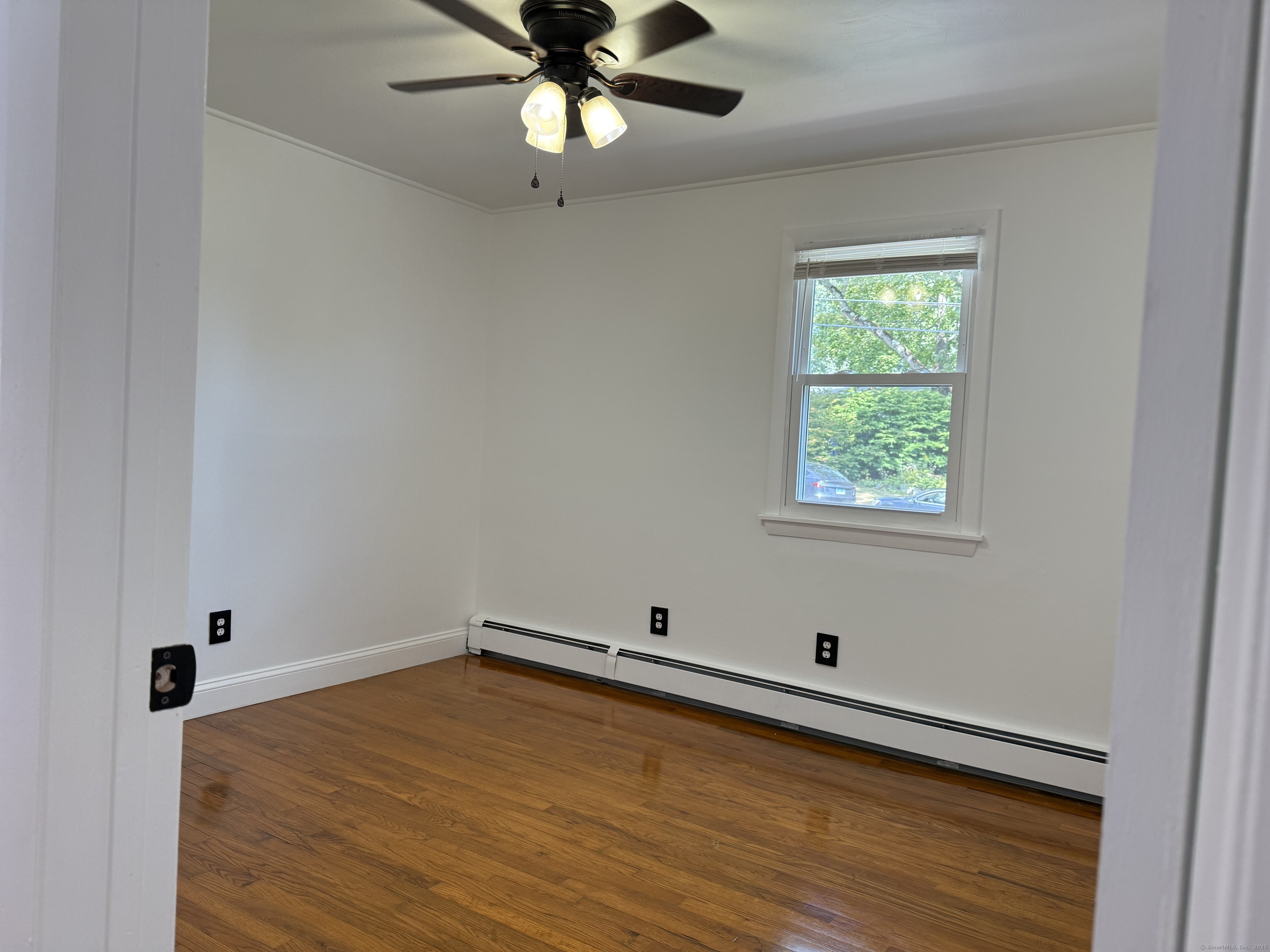 29 Blueberry Hill Road Groton, CT 06340 - Photo 12 of 29 an empty room with a window and ceiling fan
