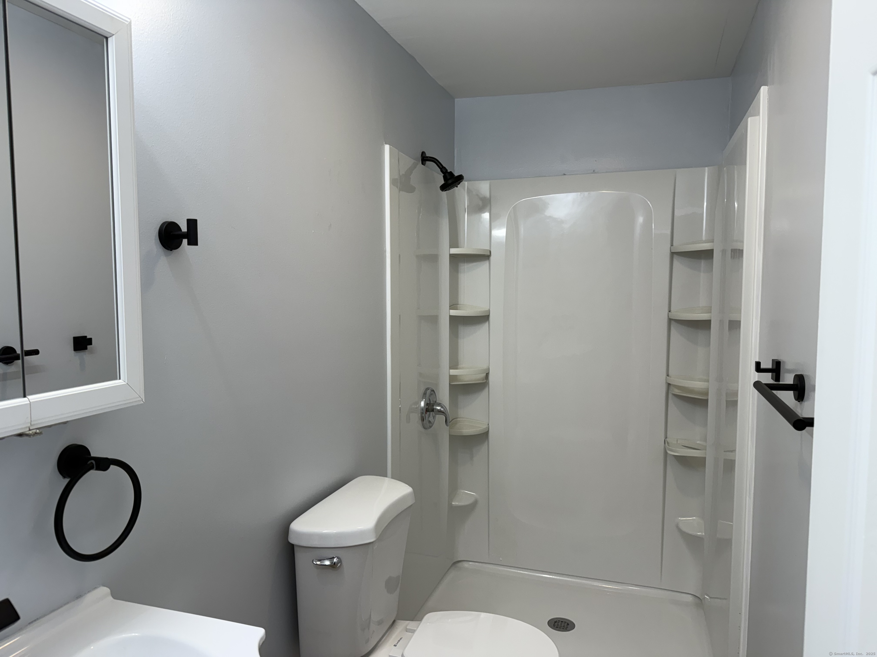 29 Blueberry Hill Road Groton, CT 06340 - Photo 13 of 29 a bathroom with a granite countertop toilet a sink and shower