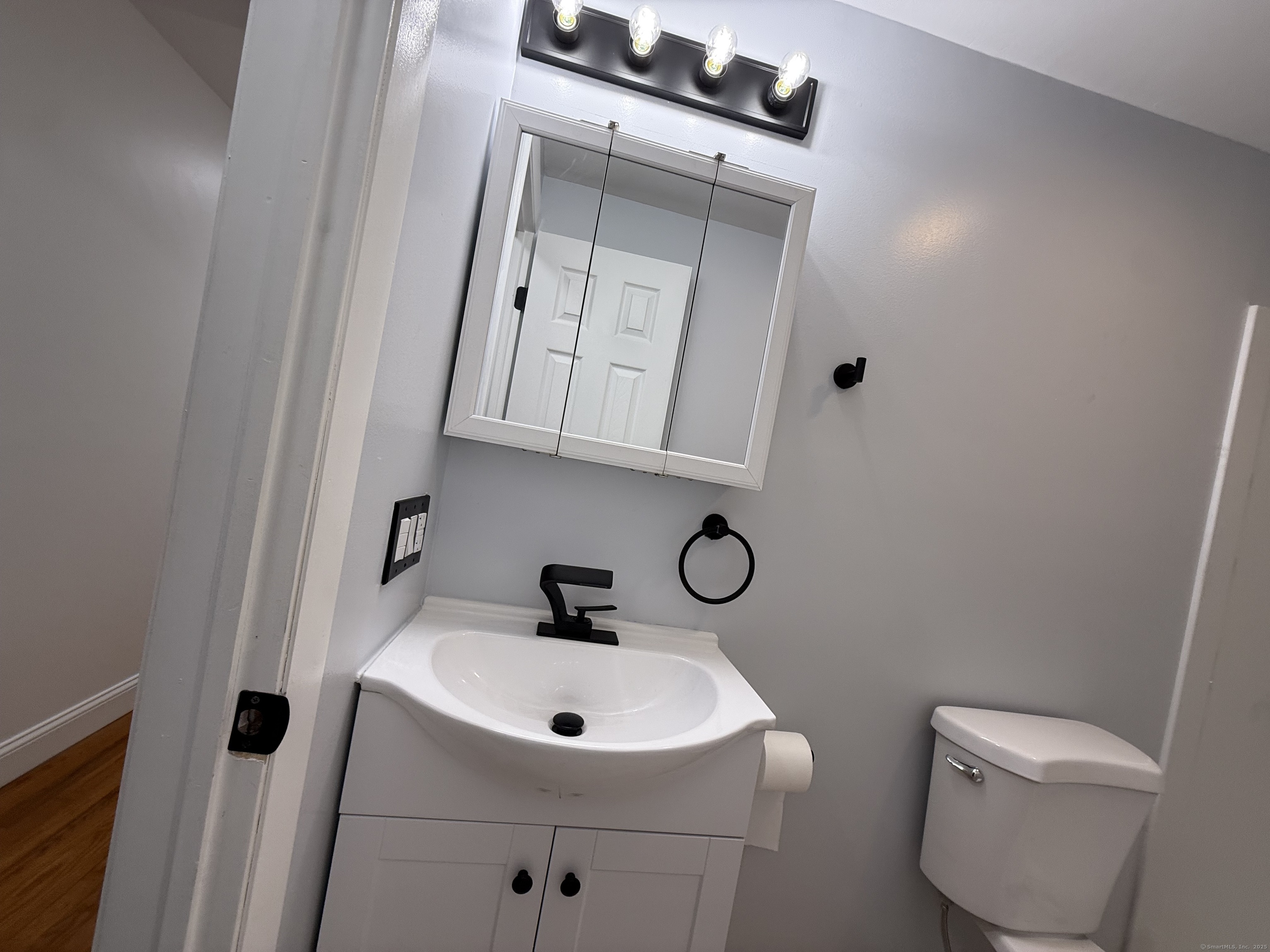 29 Blueberry Hill Road Groton, CT 06340 - Photo 14 of 29 a bathroom with a toilet sink and mirror