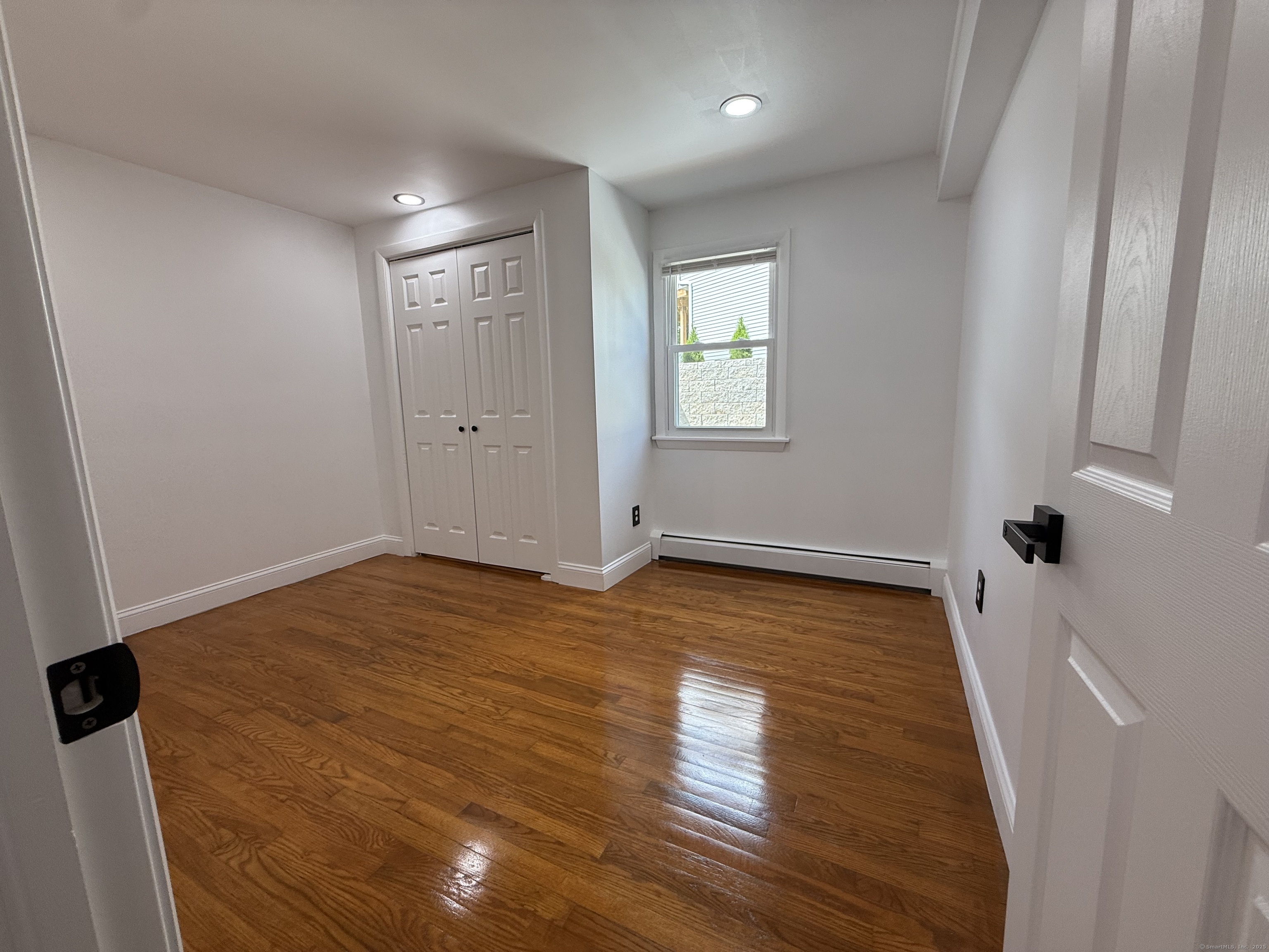 29 Blueberry Hill Road Groton, CT 06340 - Photo 15 of 29 a view of an empty room with wooden floor and a window