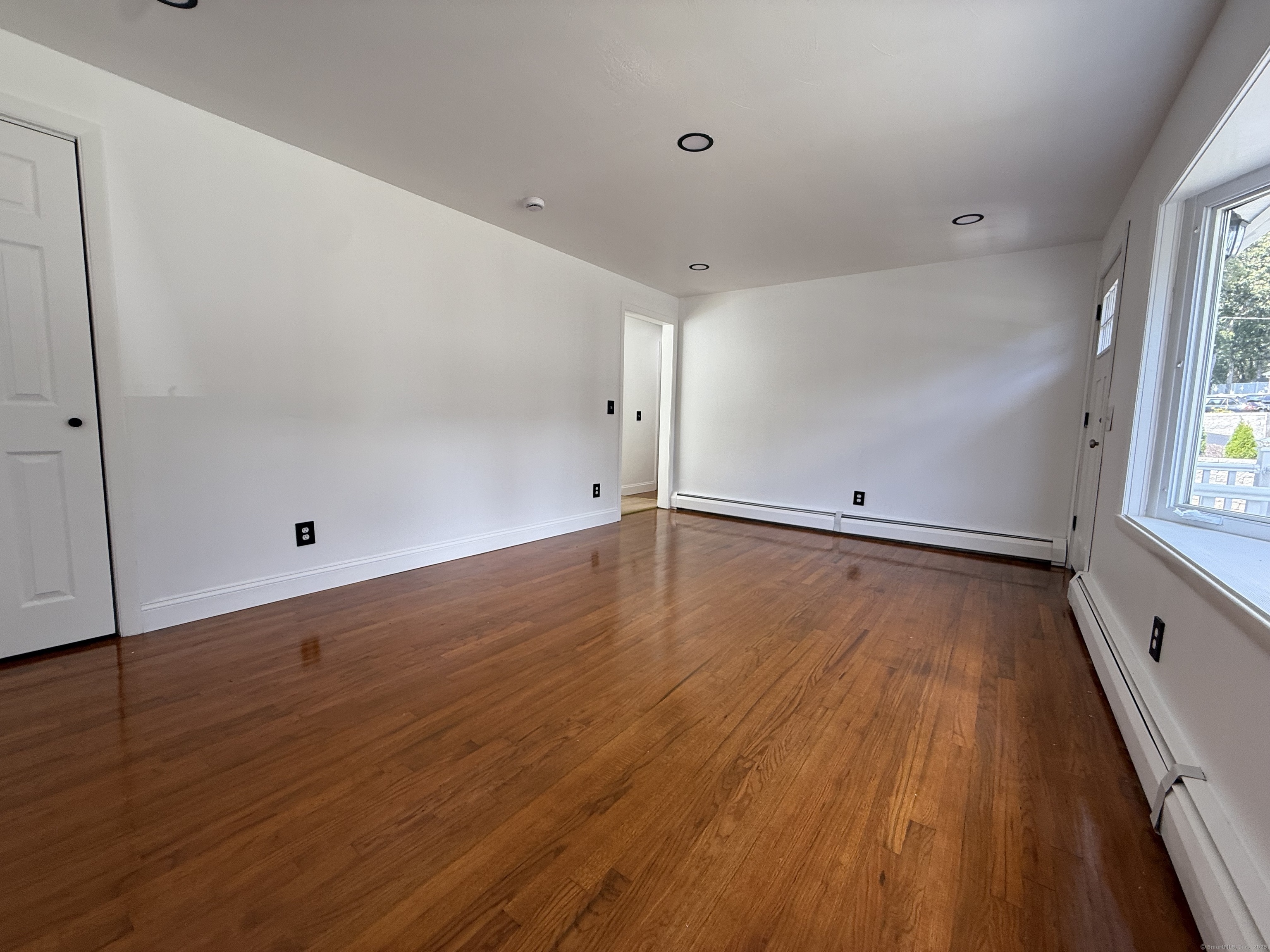 29 Blueberry Hill Road Groton, CT 06340 - Photo 19 of 29 an empty room with wooden floor and windows