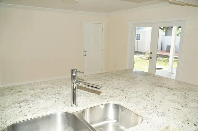 a kitchen with granite countertop a sink and a stove