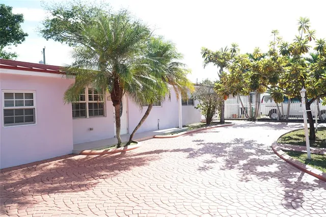 a view of a backyard with a tree