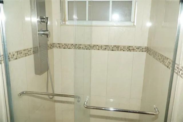 a bathroom with a glass shower door