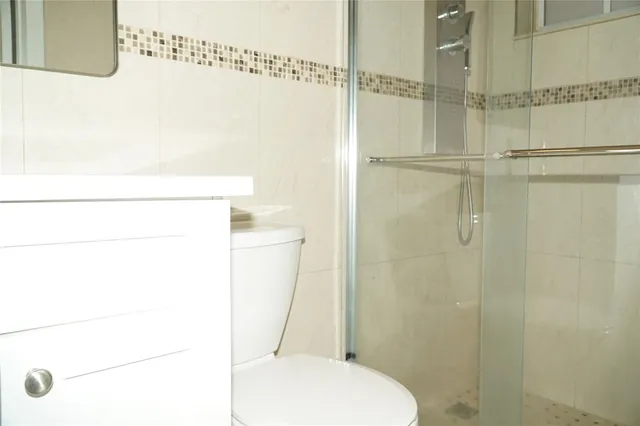 a bathroom with a toilet and a shower