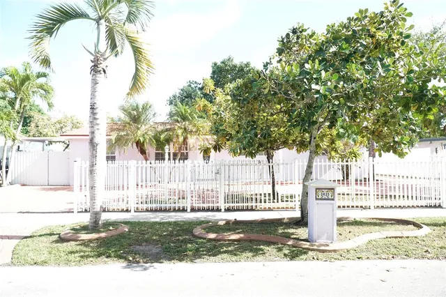 a white house that has a tree in it