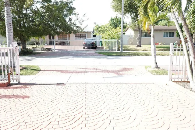 a street view with wooden fence and a trees