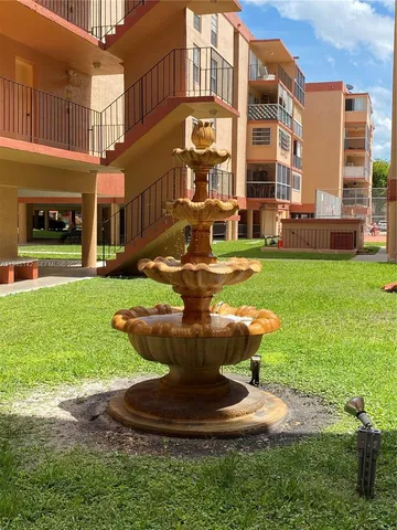 a view of a building with a yard