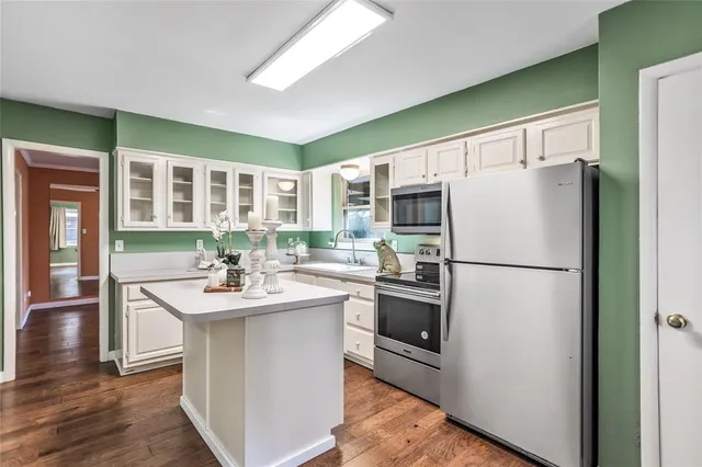 a kitchen with a sink stainless steel appliances and cabinets