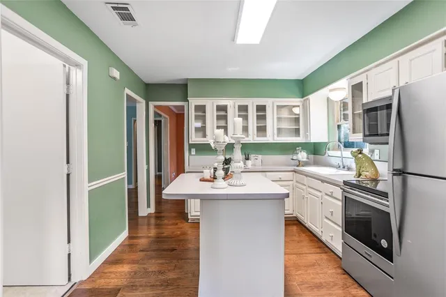 a kitchen with stainless steel appliances a sink stove and refrigerator