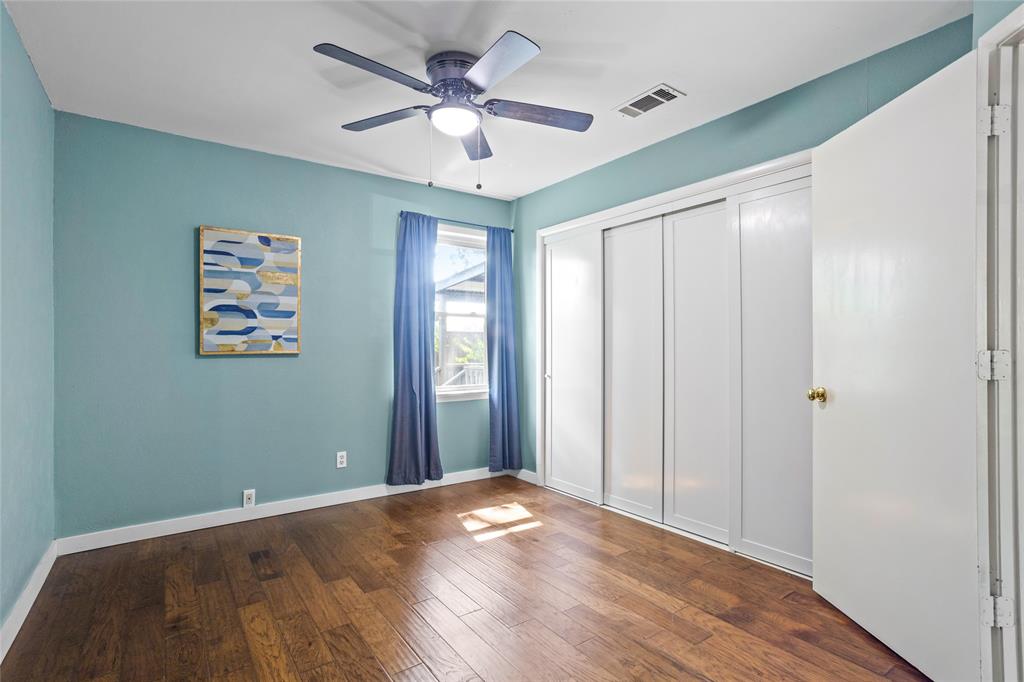 435 Hanbee Street Richardson, TX 75080 - Photo 22 of 36 Second bedroom featuring dark engineered wood floors, a ceiling fan, and nice size closet.