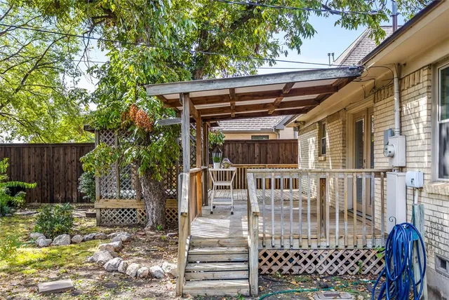 a view of a house with a wooden fence