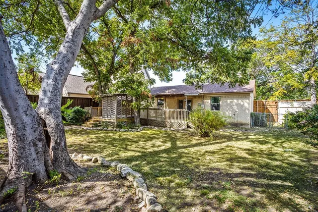 a view of a house with a tree in a yard