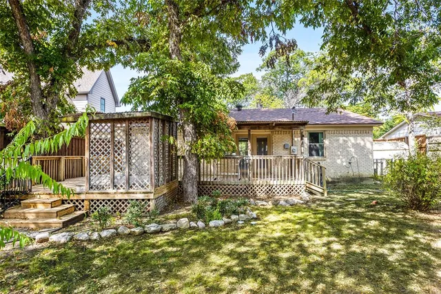 a front view of a house with a yard table and chairs