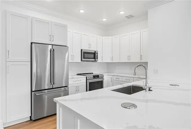 a view white cabinets and a sink