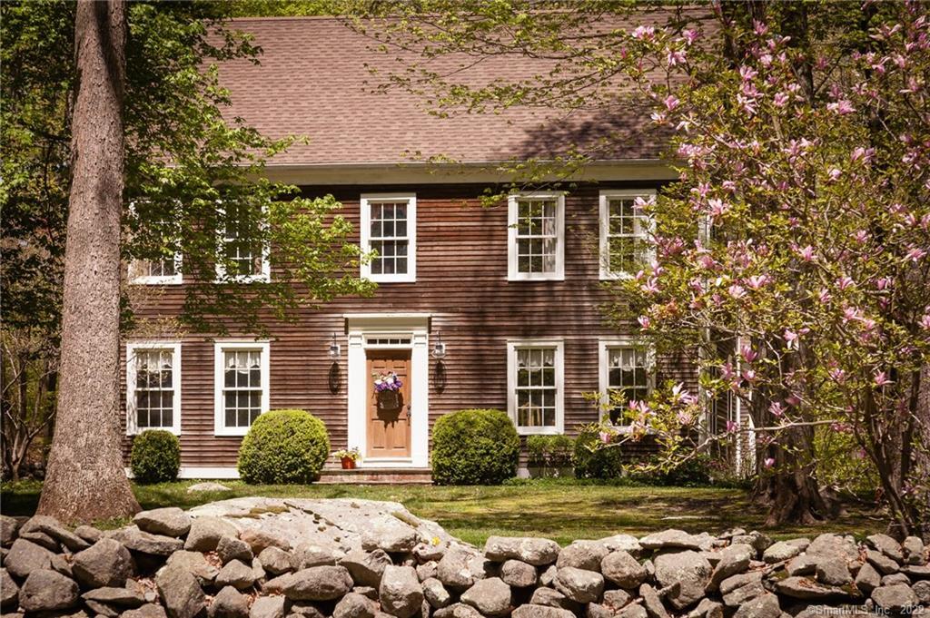 Think you are looking at an antique home? Think again! This gorgeous Colonial home in picturesque setting was built in '89. That's 1989...