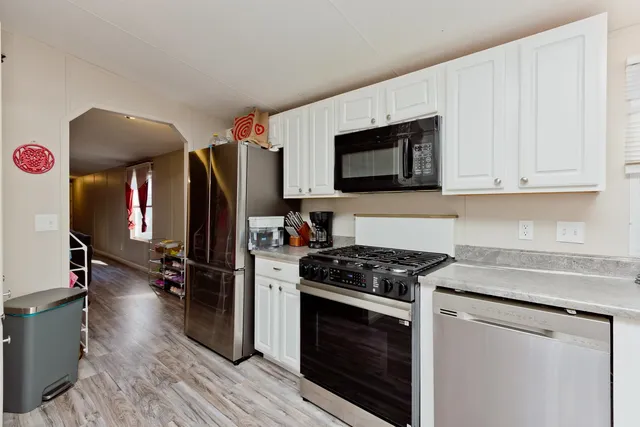 a kitchen with stainless steel appliances a stove a microwave and cabinets