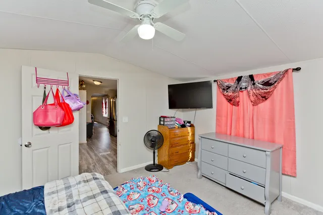 a bedroom with furniture and a flat screen tv